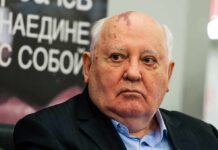 Man with bald head and birthmark looks to the side, identified as Mikhail Tumanishvili