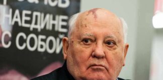 Man with bald head and birthmark looks to the side, identified as Mikhail Tumanishvili