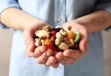 Blood Sugar Shock: Nuts Upend The Rules Hands holding mixed nuts and dried fruit