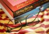 Alzheimer’s Odds Plunge With Page-Turners Round black glasses on striped scarf beside Harry Potter books