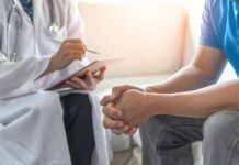 The Acid Reflux Diet That Actually Works Doctor consulting a patient on a sofa