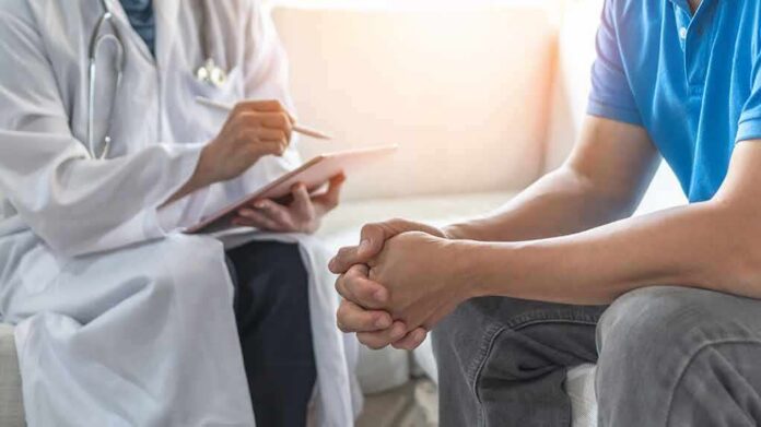 Doctor consulting a patient on a sofa