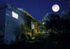 Moonlight Linked To Heart Damage RV under a full moon at a forest campsite