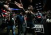 Warriors Star Steph Curry Opens Up About Rare, Irreversible Eye Condition Basketball player in arena high-fives fans while wearing headphones
