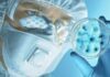 Lab Viruses Cures Cancer Scientist in protective gear examining a petri dish