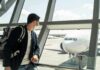 What To Do If You Forget Medications While Traveling Traveler wearing a mask looks at airplane through airport window