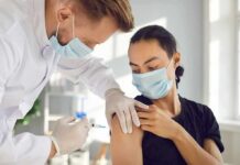 GLP-1 Hangover: Weight Rebound WARNING After Jabs Healthcare worker giving a masked patient a vaccine in the upper arm