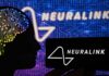 Silhouette of a head with circuitry beside Neuralink logos
