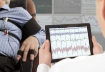 Deep Brain Stimulation for Depression Suppression Technician reviews polygraph readings on a tablet beside a seated subject