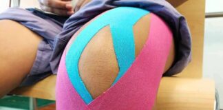 Knee with colorful kinesiology tape applied