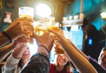 Moderate Booze, Alarming Brain Scans group toasting with beer glasses in a pub