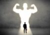 Trying To Preserve Muscle With Age? Don’t Skip These Steps Businessman with briefcase casts a large muscular shadow on wall