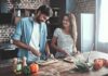 Couple preparing vegetables together in a rustic kitchen