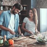 Couple preparing vegetables together in a rustic kitchen