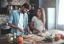 Couple preparing vegetables together in a rustic kitchen
