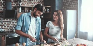 Couple preparing vegetables together in a rustic kitchen