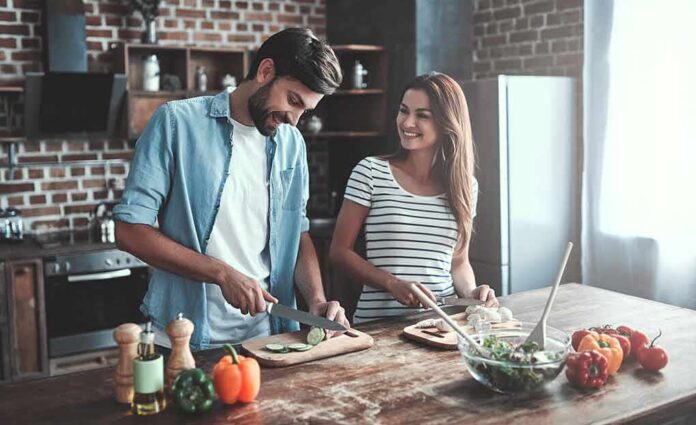 Couple preparing vegetables together in a rustic kitchen