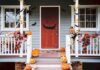 front porch decorated for Halloween with pumpkins and bats