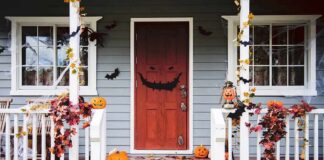front porch decorated for Halloween with pumpkins and bats