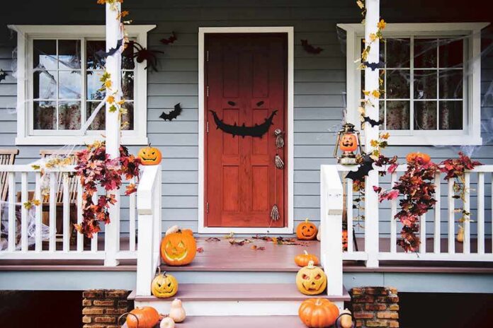 shutterstock_1172949184 front porch decorated for Halloween with pumpkins and bats