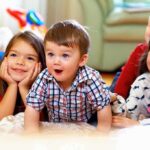 A group of children enjoying playtime indoors, displaying joyful expressions