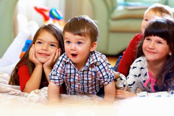 A group of children enjoying playtime indoors, displaying joyful expressions