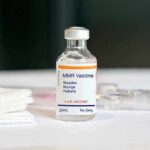 MMR vaccine vial on a white surface