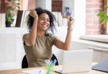 Finding Your Life’s Purpose: How to Discover Passion Daniella Alonso celebrating at a desk with a laptop