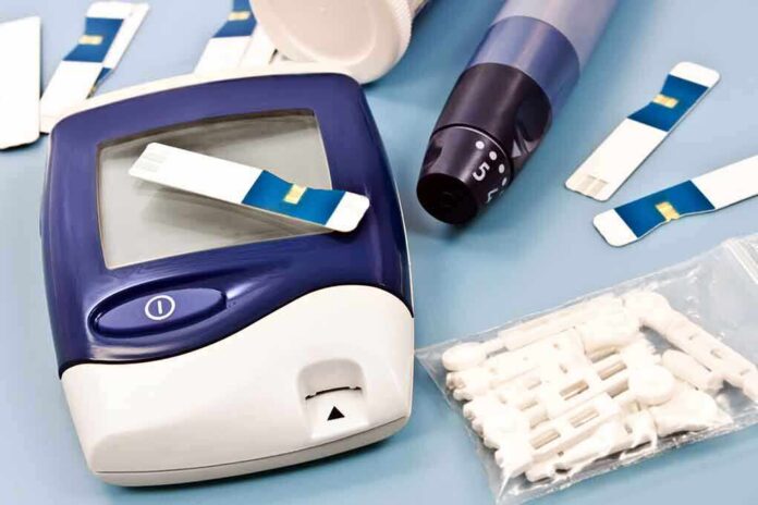 Blood glucose monitor with testing strips and a lancing device on a blue background