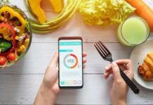 Stress Cravings Quietly Pack On Pounds hands holding phone with calorie tracker beside salad and pastry