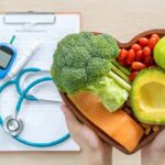Heart-shaped bowl of healthy foods with medical tools
