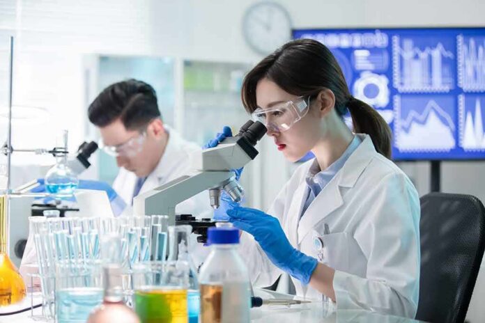 shutterstock_1530550607 Scientist using a microscope in a modern laboratory