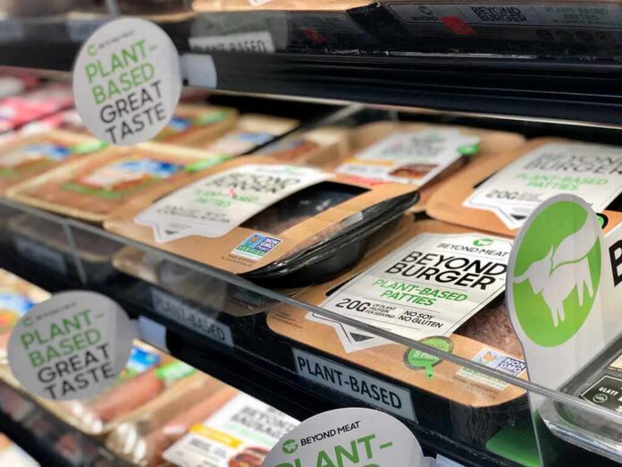 shutterstock_1556488346 Plant-based burger patties in a grocery store cooler