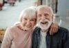 Smiling elderly couple embracing outdoors