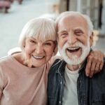 Smiling elderly couple embracing outdoors