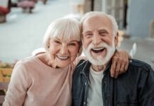 Smiling elderly couple embracing outdoors