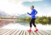 Is Just Walking Enough Workout To Keep You Fit? Older woman jogging on a wooden dock by a mountain lake
