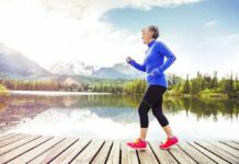 Is Just Walking Enough Workout To Keep You Fit? Older woman jogging on a wooden dock by a mountain lake
