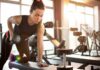 Terrified Of Gyms? Science Explains Why Woman performing dumbbell row in a gym
