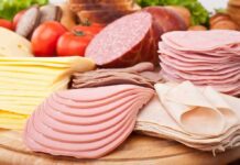Processed Meat Blamed In Stealthy Mind Drain Assorted deli meats and sliced cheese on a wooden board