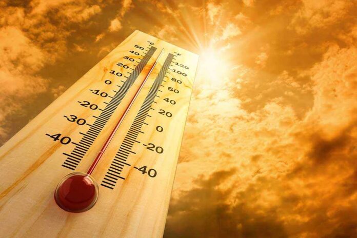 A thermometer displaying temperature against a sunset sky